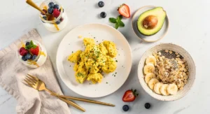 Healthy breakfast ideas that keep you full including eggs, yogurt, oats, berries, and avocado