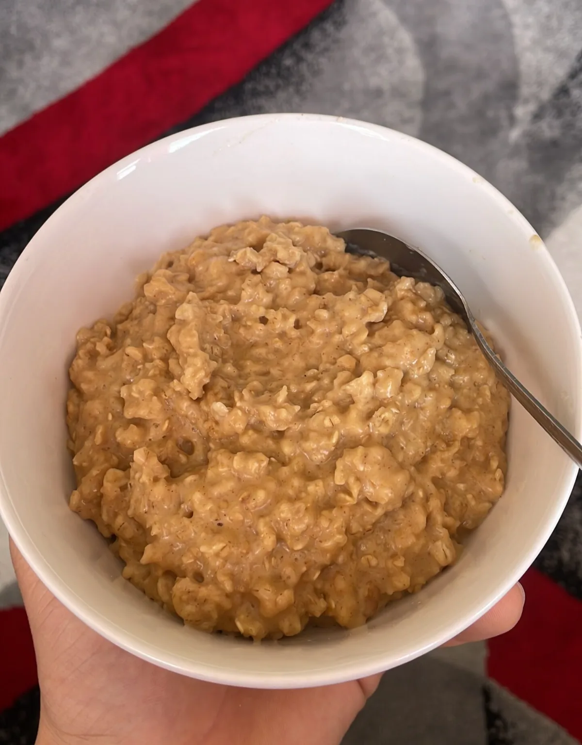Prebiotic Foods That Feed Beneficial Gut Bacteria and Reduce Cravings (The Part Nobody Talks About) Homemade bowl of cooked oatmeal held in one hand