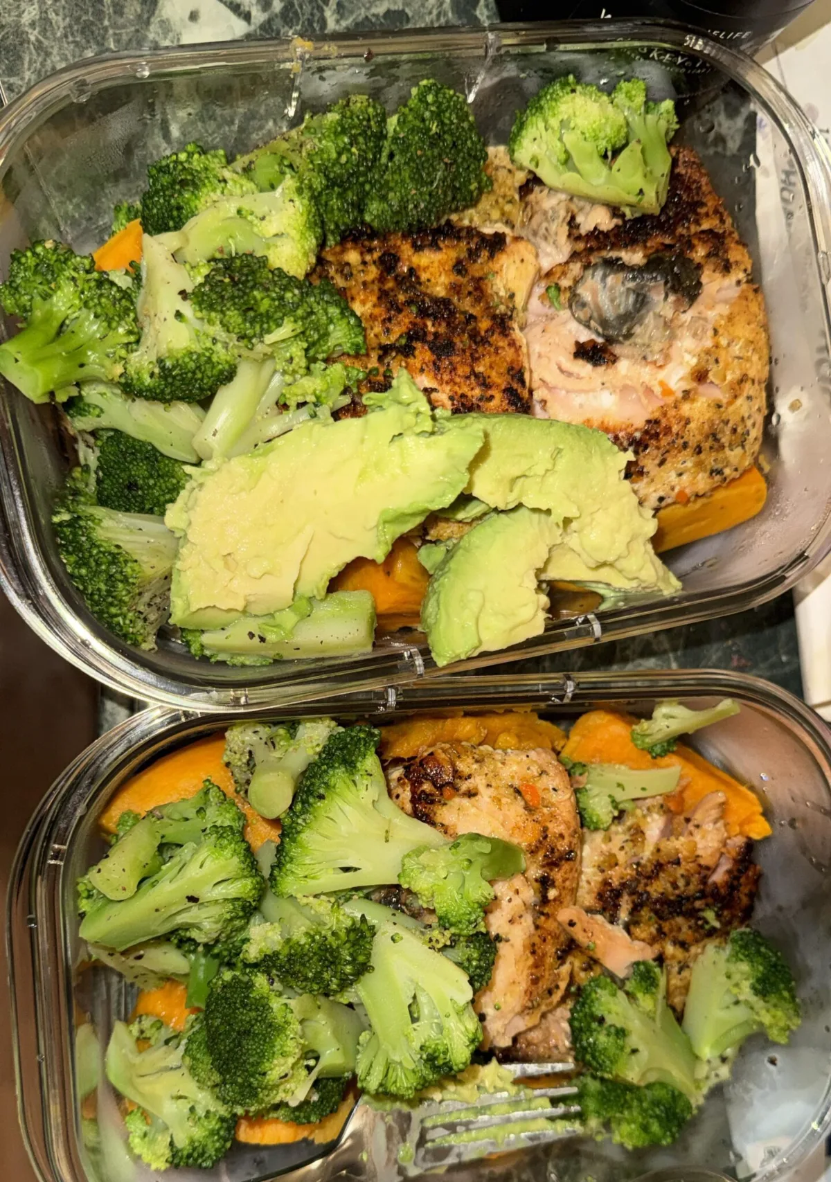 Mediterranean Lunch Ideas for Work That Actually Keep You Full Two glass lunch containers with salmon, broccoli and avocado